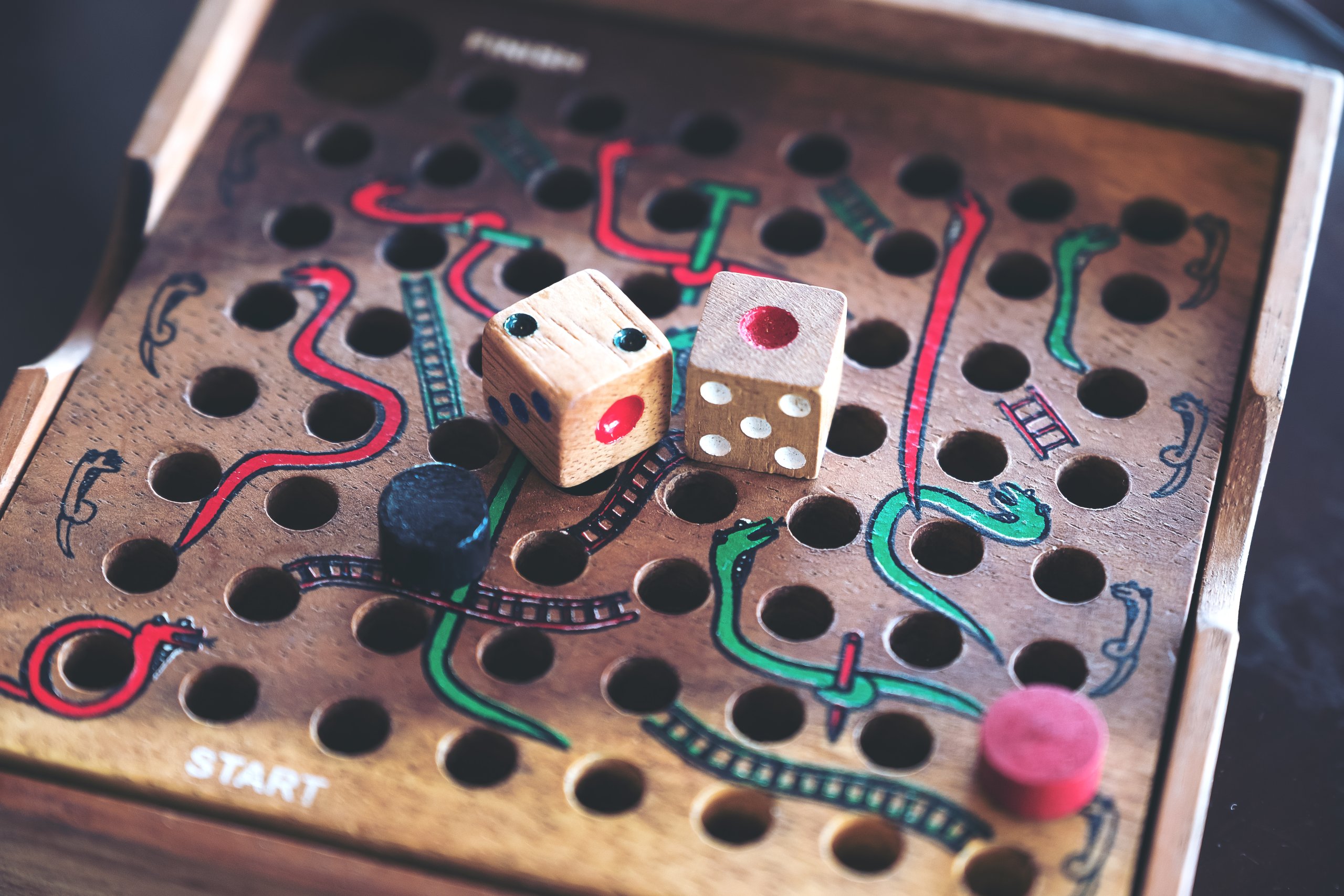 old school wooden board game of snakes and ladders