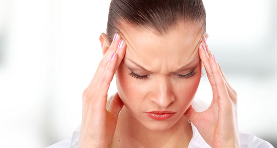 women with hands holding her temples, looking stressed and unhappy, struggling with stress and sleeplessness